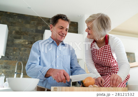 Senior couple in the kitchen cooking together. 28121532