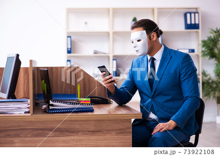 Young male employee wearing mask in the office 73922108