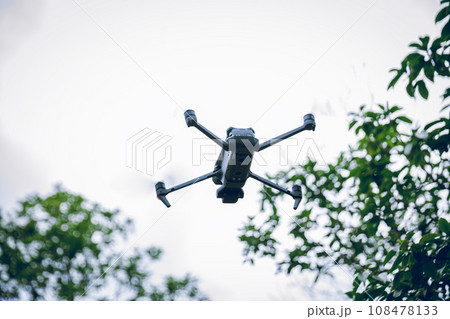 Flying drone in summer forest 108478133