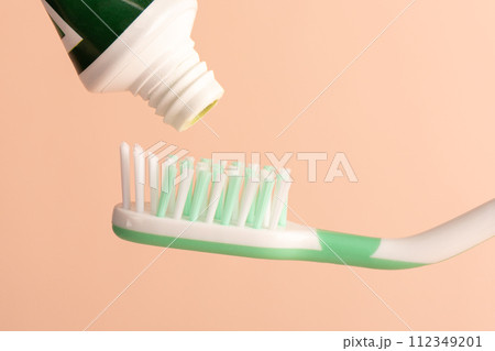 Toothbrush and tube of toothpaste before squeezing the paste onto the brush. 112349201