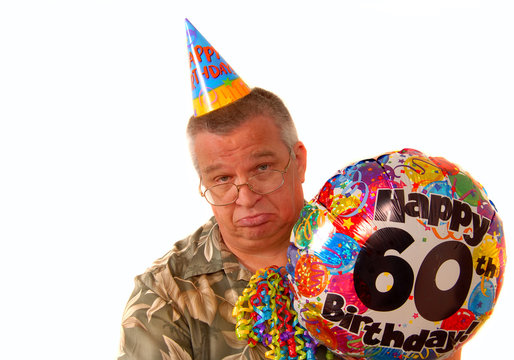 Sad man holding a balloon for a 60th birthday party