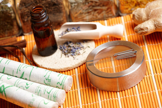 Acupuncture needles, moxa sticks and lavender petals