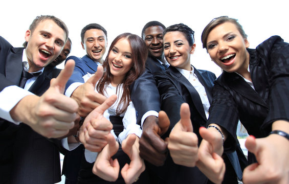 Happy multi-ethnic business team with thumbs up in