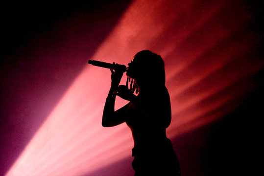 Silhouette of an unrecognizable female singer