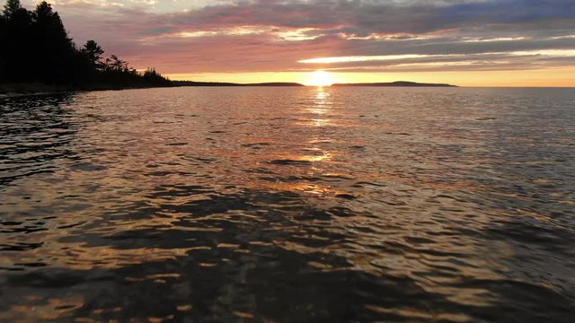 Weekend trip to Bois Blanc Island next to Mackinac Island with Warm Summer Sunset fling drone over the water for epic logo shot