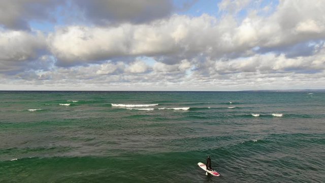 Winter stand up paddle surfing in Northern Michigan Charlevoix Petoskey Area on Lake Michigan logo shot logo here