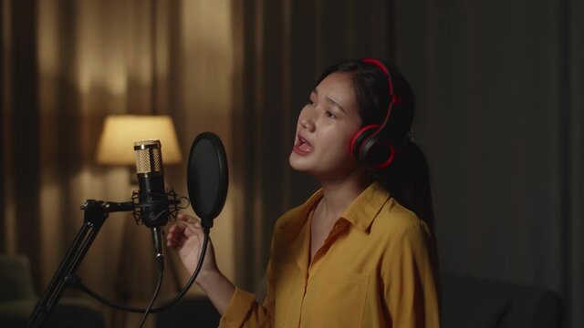 Young Woman Singing In Home Studio
