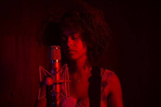 Black Woman Singing And Playing Guitar. 