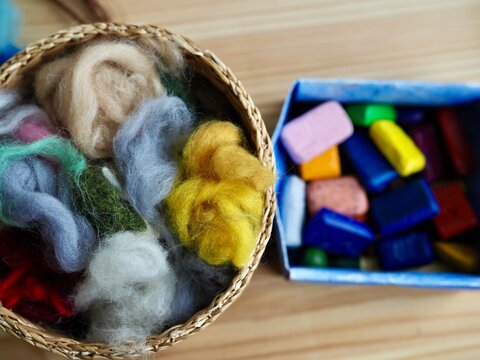 basket with a set of colored wool for felting