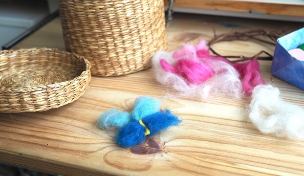 basket with a set of colored wool for felting