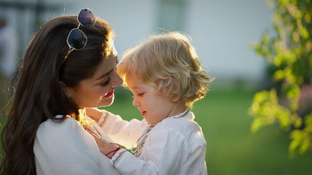 Mother's Embrace at Golden Hour. Tender moment between mother and child in warm sunset light.