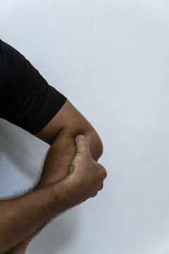 Man, pointing to his epicondylitis pain. Concept of injury and pain.