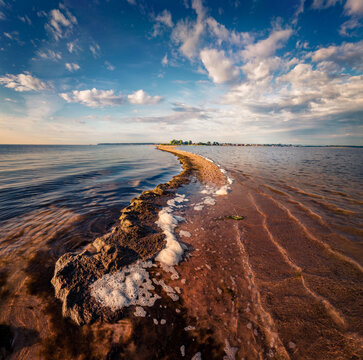 Attractive summer seascape of Baltic sea with the end of the sandbar. Colorful endless clouds  in colorful sky. Amazing morning scene of Rewa public beach, Poland. Vacation concept background.