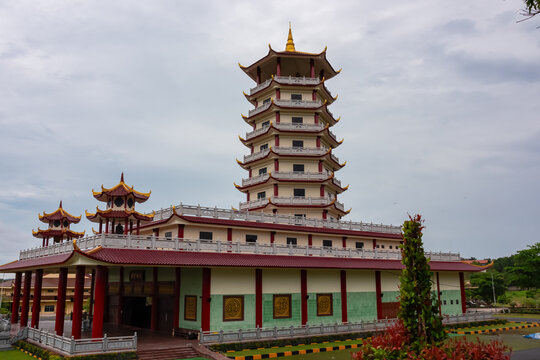 Multi-story structure with a distinctive pagoda-style roof in Chinese temple complex Patung Seribu (Vihara Ksitigarbha Bodhisattva, 500 Lohan Temple) on Bintan Island, Indonesia, Asia. Dramatic sky