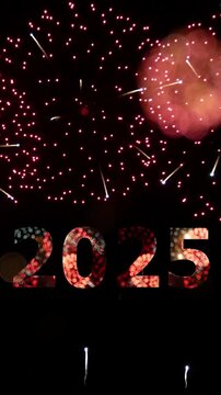 4K vertical. loop seamless of firework of year 2025 greeting during new year eve countdown celebration, real illuminate fireworks festival in the sky display at night with colorful