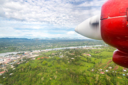 Air travel in Fiji, Melanesia, Oceania. View of Rewa river, Nausori town, Viti Levu island from a window of a small turboprop propeller airplane bound for Vanua Levu, Tuvalu or Levuka, Ovalau island.