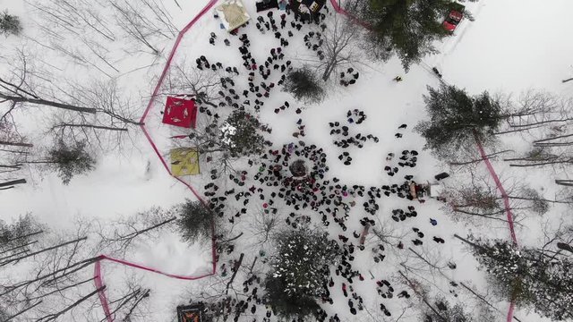 Winter party in the woods in Traverse City Michigan 4K drone shots over forest and open woods in winter snow covered scene place logo here