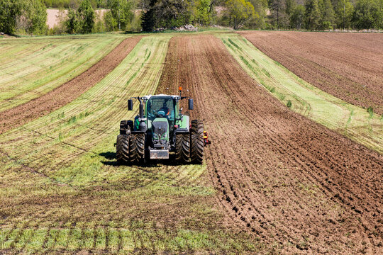 Tractor harrowing field