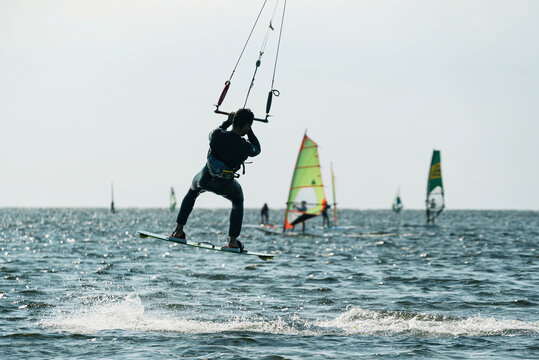 Kiteboard or kitesurfing tricks. Summer sport learning how to kitesurf. Kite surfing on Puck bay in Jastarnia, Poland