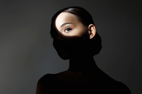 portrait of young woman with light on her face