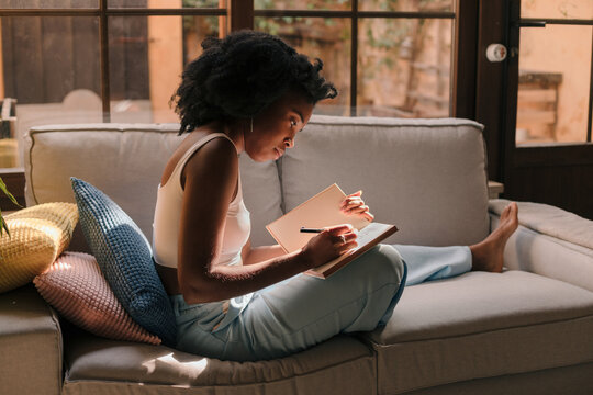 Inspired woman writing in a journal