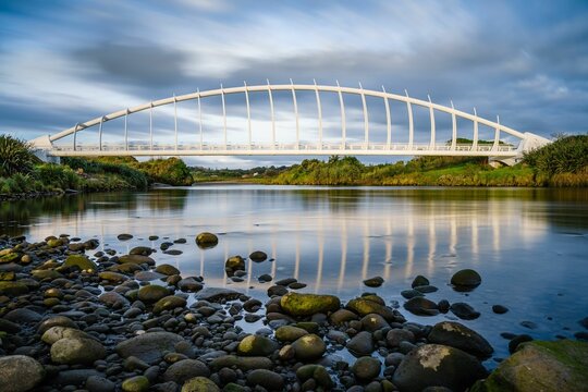 Beautiful view of the Te Rewa Rewa Bridge under a cloudy blue sky in New Plymouth, New Zealand