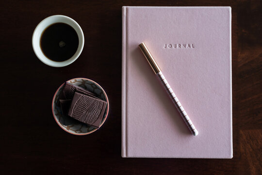 journal book with chocolate and coffee