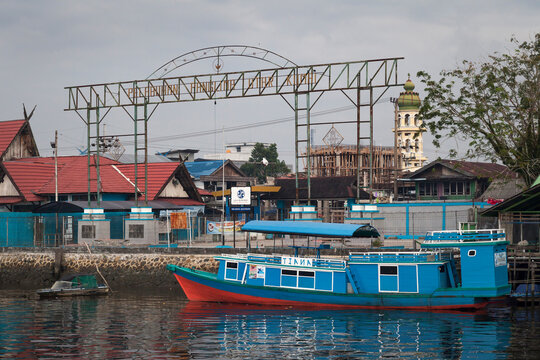 Traditional wooden Klotok (Indonesian river boat) moored in Kumai Port, Borneo