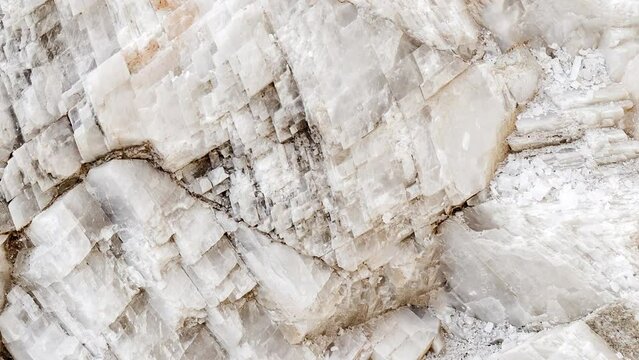 Crystals of mineral white Icelandic spar, selective focus, moving sideways, close-up macro, top view