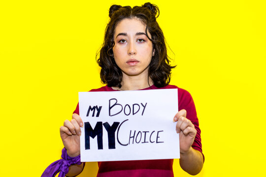 Determined Woman Holding "My Body My Choice" Sign