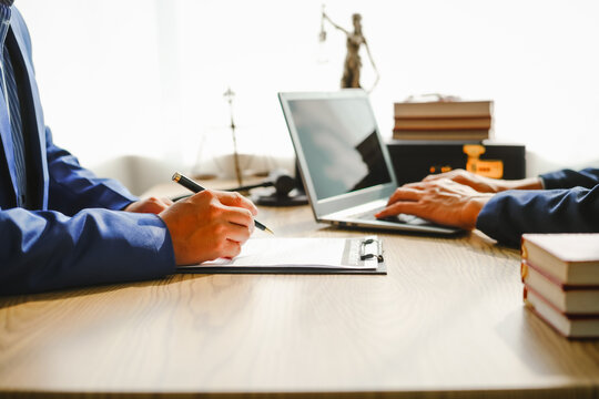 Legal expert navigating corruption cases, including bribery and graft. Businessman consults at desk. Discussions involve bribery, corruption, buying off, and corrupt practices.