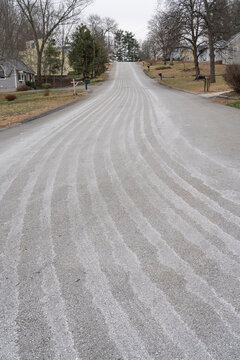 residential street with snow melt salt tracks