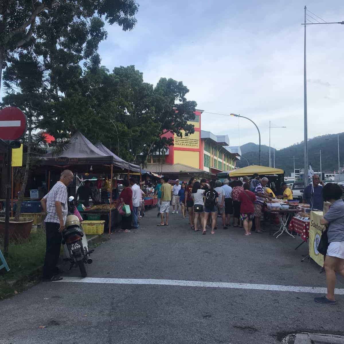 Busy streets of Tanjung Bungah with stalls on every side.