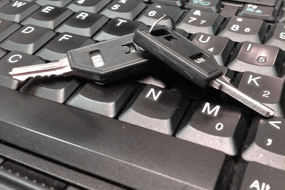 Car keys on a computer keyboard.