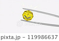 Yellow Diamond Held in Tweezers for Precise Jewelry Inspection 119986637