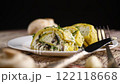 baked potato roll with cottage cheese filling with garlic and mushrooms, isolated on black background 122118668