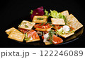 small snack canapes with crackers and lightly salted red fish Salmon, isolated on black background 122246089