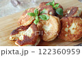 cooked fried pea pies on a wooden board . 122360959