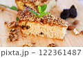 Sponge cake with prunes and nuts on wood 122361487