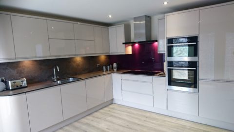 Large kitchen in white gloss includes eye level built in double oven