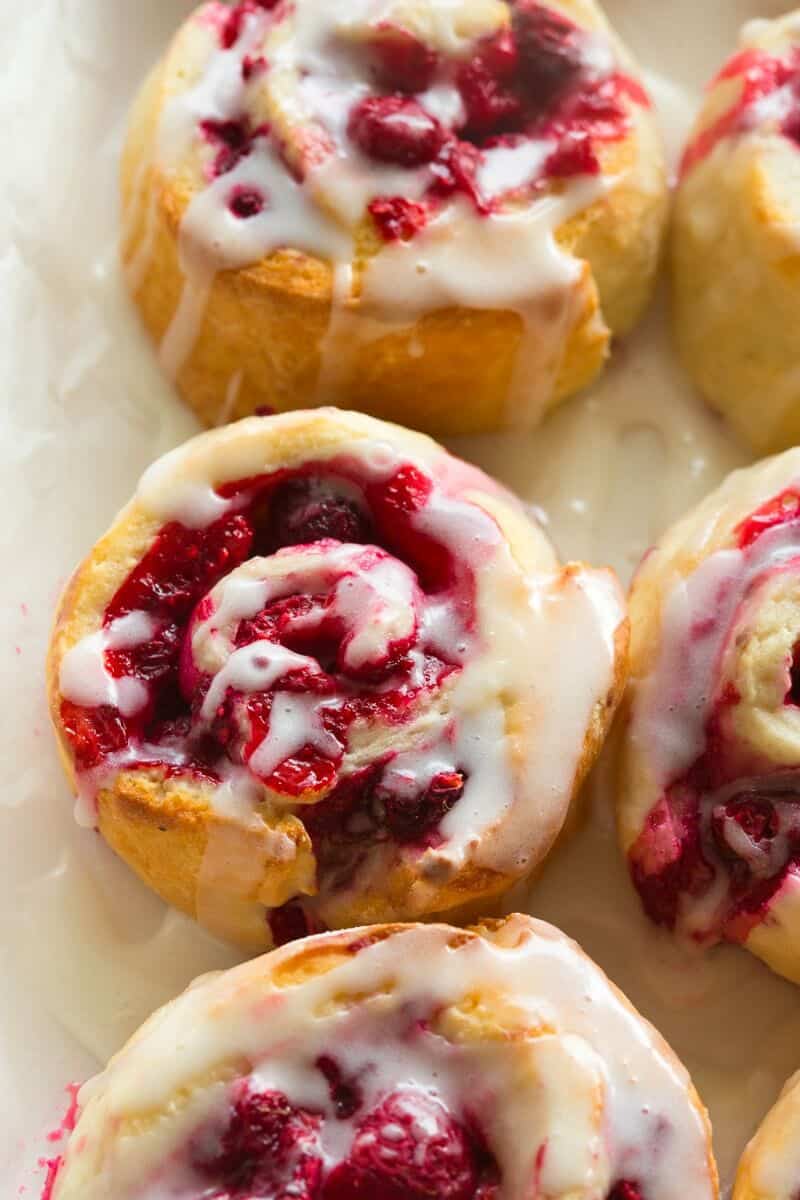 raspberry sweet rolls with a vanilla glaze on top. 