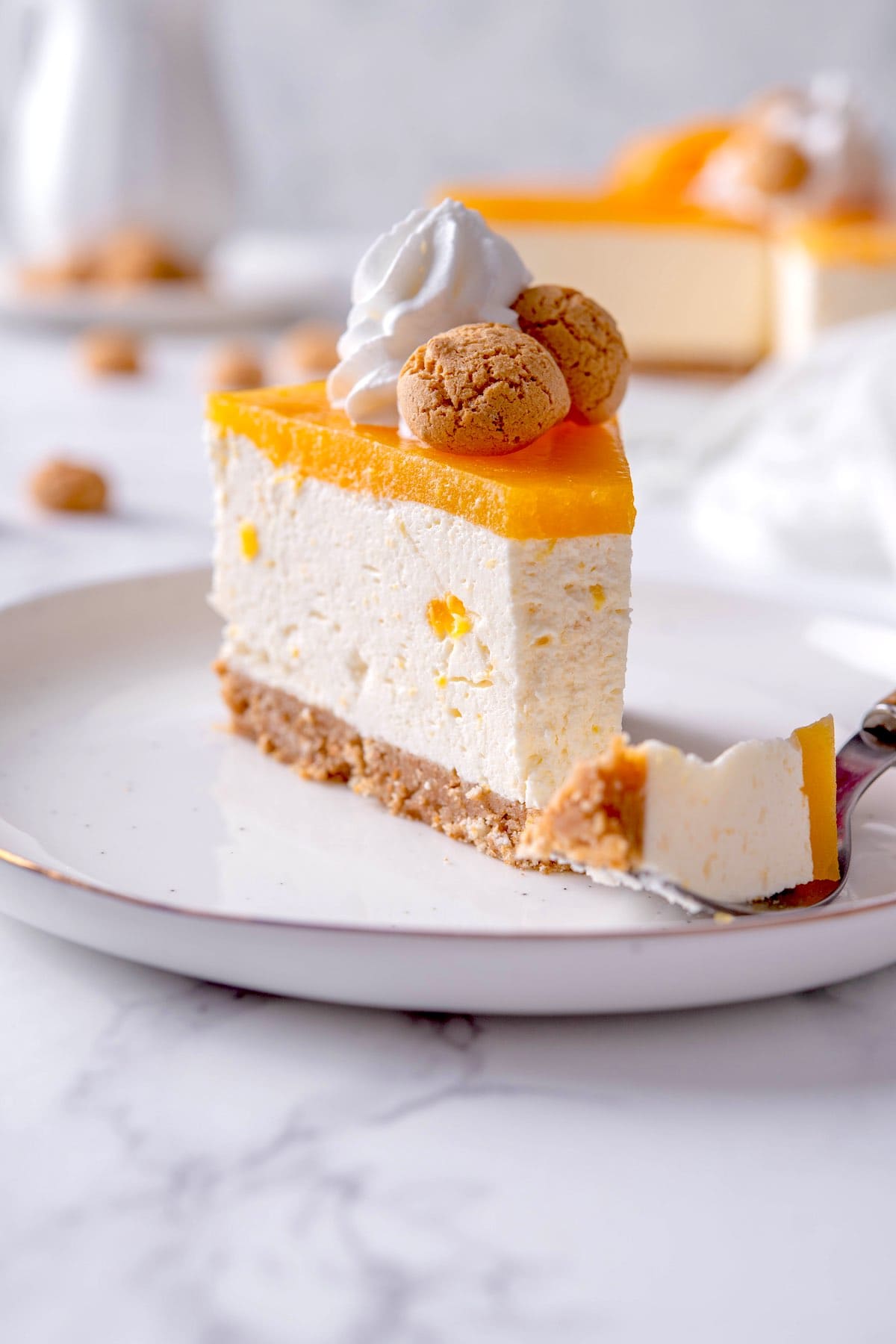 homemade peach cheesecake on a white plate.