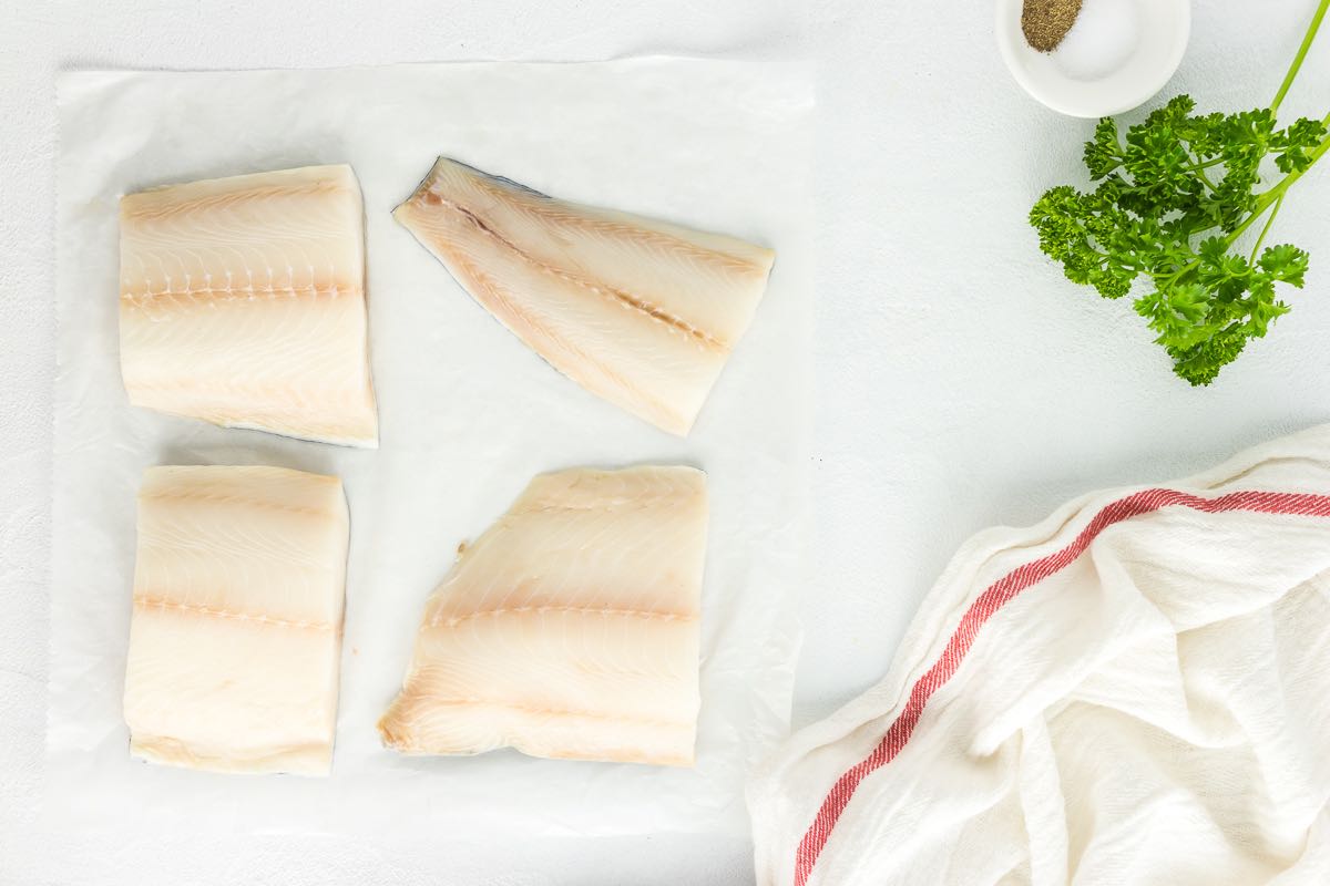 patting dry grouper fillets.