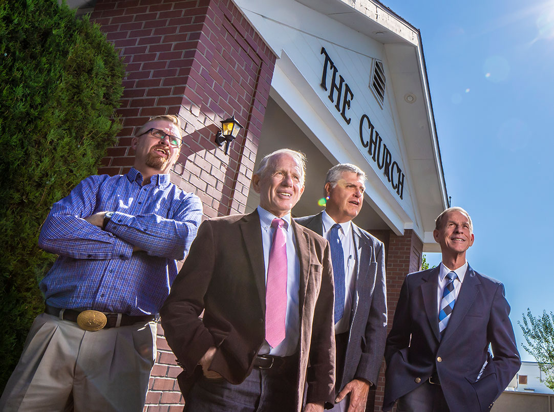 men standing outside the church at reno