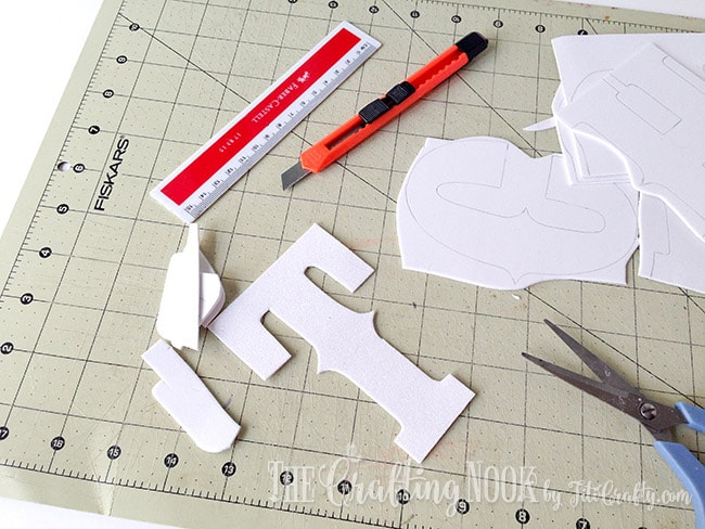 cutting the letters with scissors or cutter