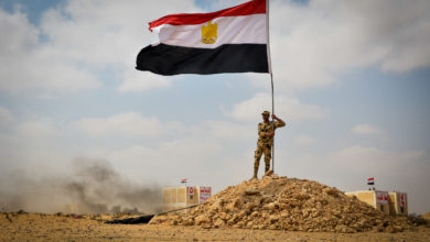 Egyptian soldier with the national flag