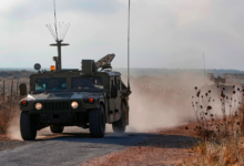 An Israeli military vehicle patrols near the Syrian border in the Israeli-annexed Golan Heights on Aug. 3, near the location where the army said it killed four men placing explosives at a security fence.