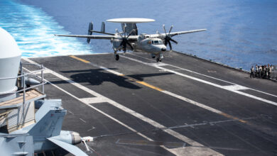 220810-N-WU964-1044 PHILIPPINE SEA (Aug. 10, 2022) Cmdr. Edmund Poynton, commanding officer of the Tigertails of Airborne Early Warning Squadron (VAW) 125 lands on the flight deck of the U.S. Navy’s only forward-deployed aircraft carrier USS Ronald Reagan (CVN 76) in an E-2D Hawkeye after a change of command ceremony, in the Philippine Sea, Aug. 10. During the change of command ceremony Cmdr. David Wiltshire transferred command of VAW 125 to Poynton. Ronald Reagan, the flagship of Carrier Strike Group 5, provides a combat-ready force that protects and defends the United States, and supports alliances, partnerships and collective maritime interests in the Indo-Pacific region. (U.S. Navy photo by Mass Communication Specialist 3rd Class Dallas A. Snider)