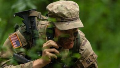 Cadet coordinates an attack plan through his Field Radio Backpack during a Field Training Exercise at Fort Knox