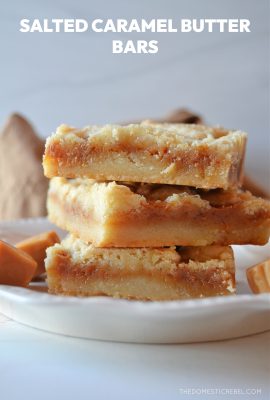 a trio stack of salted caramel butter bars on a white plate with little caramel squares next to them.